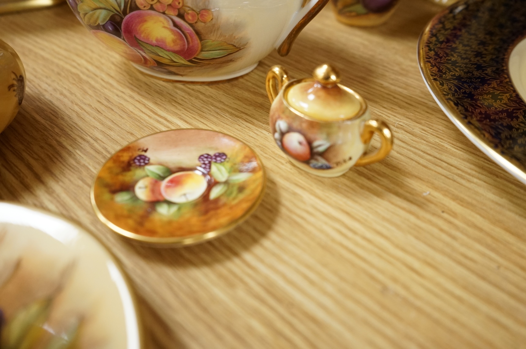 A collection of Aynsley ‘Orchard Gold’ fruit-painted tea/dinner wares and vases, largely signed by D Jones, largest 26cm in diameter